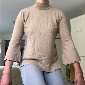 Tan mock neck sweater with scalloped detailing